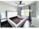 This bedroom has a modern style with wood floors and a fan at 612 Arbor Lake Ln, Tampa, FL 33602