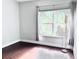 Sun-filled bedroom with wood floors, a large window and decorative modern lamp at 612 Arbor Lake Ln, Tampa, FL 33602