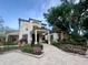 Charming clubhouse with a beautiful entryway, lush landscaping, and manicured flowerbeds at 612 Arbor Lake Ln, Tampa, FL 33602