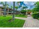 Beautifully landscaped exterior with manicured lawn and inviting walkway to building entrance at 612 Arbor Lake Ln, Tampa, FL 33602