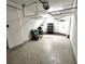 Spacious garage with speckled floors, overhead storage racks, and washer and dryer hookups at 612 Arbor Lake Ln, Tampa, FL 33602