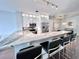 Modern kitchen with white cabinetry, stainless steel appliances, and a beautiful marble waterfall island with seating at 612 Arbor Lake Ln, Tampa, FL 33602