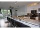 Beautiful kitchen featuring stainless steel appliances, granite counters, a long breakfast bar and a view to the balcony at 612 Arbor Lake Ln, Tampa, FL 33602