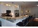 Well-equipped kitchen with sleek countertops, stainless appliances, and stylish bar stool seating at 612 Arbor Lake Ln, Tampa, FL 33602