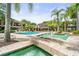 Inviting community pool area with lush landscaping, fountains, and comfortable lounge chairs at 612 Arbor Lake Ln, Tampa, FL 33602