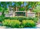 Entrance to Island Walk Private Residences with lush tropical landscaping and manicured hedges at 612 Arbor Lake Ln, Tampa, FL 33602