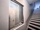 Bright staircase with a modern metal handrail featuring dark wood treads and a large mirror at 612 Arbor Lake Ln, Tampa, FL 33602
