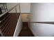 A view down a staircase with modern metal handrails and dark wood treads at 612 Arbor Lake Ln, Tampa, FL 33602