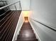 A view of a modern staircase with wood treads, stainless steel railings, and recessed lighting at 612 Arbor Lake Ln, Tampa, FL 33602