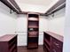 Spacious walk-in closet featuring wood cabinets, shelving, and safe for secure storage at 612 Arbor Lake Ln, Tampa, FL 33602