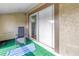 Outdoor screened-in patio includes green turf and seating for comfortable enjoyment at 6309 Newtown Cir # 9B2, Tampa, FL 33615