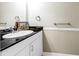 Bright powder room with framed mirror, black countertop and neutral wall color at 6309 Newtown Cir # 9B2, Tampa, FL 33615