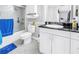 Bathroom with white cabinetry, black granite countertops, a toilet and tub with shower at 6309 Newtown Cir # 9B2, Tampa, FL 33615