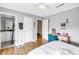 Bedroom featuring wood floors, large desk, and ensuite bathroom at 6309 Newtown Cir # 9B2, Tampa, FL 33615