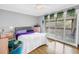 Bedroom features a cozy bed, pink dresser, and a sliding door to the balcony at 6309 Newtown Cir # 9B2, Tampa, FL 33615