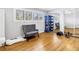 Bedroom with hardwood floors, gray chair, white shutters, and large mirrored closet at 6309 Newtown Cir # 9B2, Tampa, FL 33615
