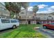 Exterior shot of townhomes with well-kept landscaping, parking, and balconies at 6309 Newtown Cir # 9B2, Tampa, FL 33615