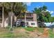 Exterior of the condo with balconies overlooking the canal, mature trees, and well-maintained landscaping at 6309 Newtown Cir # 9B2, Tampa, FL 33615