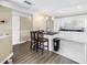 Bright kitchen boasts white cabinetry, black countertops and pendant lighting above breakfast bar at 6309 Newtown Cir # 9B2, Tampa, FL 33615