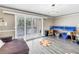 Bright living room features sliding glass doors, wood-look flooring and decorative lighting at 6309 Newtown Cir # 9B2, Tampa, FL 33615