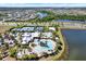 Wide aerial view showcases community amenities: tennis courts, a playground, and a resort-style pool with surrounding homes at 6909 Crestpoint Dr, Apollo Beach, FL 33572