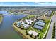 A stunning aerial view of the community, highlighting the pool, clubhouse, lake, and recreational courts at 6909 Crestpoint Dr, Apollo Beach, FL 33572