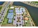 Aerial view of a community clubhouse with pools, tennis courts, and a playground, providing a variety of recreational options at 6909 Crestpoint Dr, Apollo Beach, FL 33572
