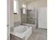 Bathroom with a separate soaking tub and glass-enclosed shower at 6909 Crestpoint Dr, Apollo Beach, FL 33572