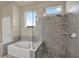 Bright bathroom showcasing a glass-enclosed shower and separate soaking tub with natural light at 6909 Crestpoint Dr, Apollo Beach, FL 33572