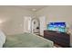 This bedroom features an arched mirror and a TV to add comfort and style at 6909 Crestpoint Dr, Apollo Beach, FL 33572