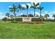 Waterset community sign surrounded by lush green landscaping, colorful flowers, and palm trees at 6909 Crestpoint Dr, Apollo Beach, FL 33572