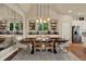 Bright dining room with modern lighting, hardwood floors, and a decorative mirror creating a welcoming atmosphere at 6909 Crestpoint Dr, Apollo Beach, FL 33572