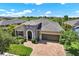 Attractive single-Gathering home with a brick driveway, two-car garage, and neatly landscaped yard at 6909 Crestpoint Dr, Apollo Beach, FL 33572