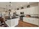 Bright kitchen featuring white cabinets, stainless steel appliances, granite countertops, and hardwood flooring at 6909 Crestpoint Dr, Apollo Beach, FL 33572