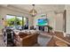 Cozy living room with a plush leather sofa, modern lighting, and a view of the outdoor pool area at 6909 Crestpoint Dr, Apollo Beach, FL 33572
