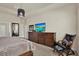 Bedroom with king bed, dark wood dresser, TV, and a comfortable black leather chair at 6909 Crestpoint Dr, Apollo Beach, FL 33572