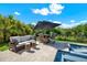 Outdoor patio area with a dining table and lounge seating next to a sparkling pool at 6909 Crestpoint Dr, Apollo Beach, FL 33572