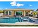 Relax in this backyard pool featuring a sun shelf, and an outdoor kitchen and dining area at 6909 Crestpoint Dr, Apollo Beach, FL 33572