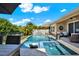 Enjoy this backyard pool featuring a waterfall, lounge chairs, and a lush tropical landscape at 6909 Crestpoint Dr, Apollo Beach, FL 33572