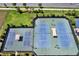 Aerial view of the community tennis and pickleball courts with sunshades, showcasing recreational amenities at 6909 Crestpoint Dr, Apollo Beach, FL 33572