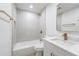Bathroom featuring tiled shower/tub, marble countertop, and gold fixtures at 7607 22Nd W Ave, Bradenton, FL 34209