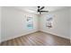 Bright bedroom with wood floors and view of pool and backyard through windows at 7607 22Nd W Ave, Bradenton, FL 34209
