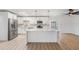Modern kitchen with stainless steel appliances, white cabinets, quartz countertops and open view to the pool area at 7607 22Nd W Ave, Bradenton, FL 34209