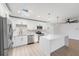 Modern kitchen with white cabinetry, stainless appliances, quartz counters and natural light from a skylight at 7607 22Nd W Ave, Bradenton, FL 34209