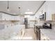 Modern kitchen showcasing stainless steel appliances, quartz countertops, and elegant gold hardware at 7607 22Nd W Ave, Bradenton, FL 34209