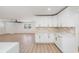 Bright, open-concept space with a modern kitchen featuring white cabinets and gold hardware at 7607 22Nd W Ave, Bradenton, FL 34209