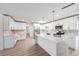 Bright kitchen featuring white cabinets, stainless steel appliances, and a spacious island at 7607 22Nd W Ave, Bradenton, FL 34209