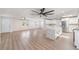 Open living room with kitchen view, featuring sleek ceiling fans and ample natural light at 7607 22Nd W Ave, Bradenton, FL 34209