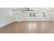 Spacious living room featuring hardwood floors, a door to the outside, and modern ceiling fans at 7607 22Nd W Ave, Bradenton, FL 34209