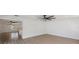 Bright open-concept living room featuring sleek ceiling fans and ample natural light with kitchen view at 7607 22Nd W Ave, Bradenton, FL 34209